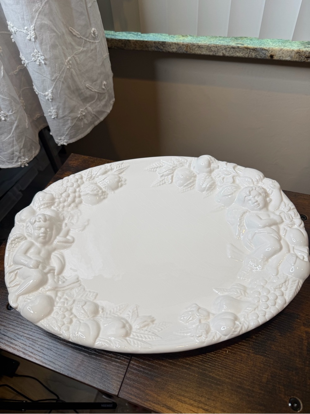White glazed ceramic oval serving platter classical bacchanalian cherub embossed